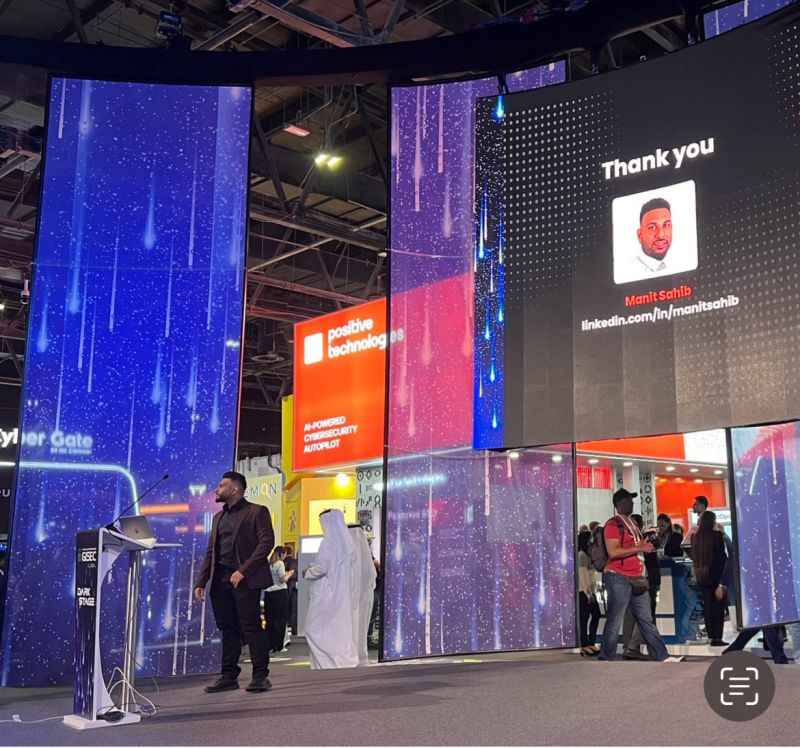 Manit Sahib on the GISEC Global Dark Stage, name on the main screen
